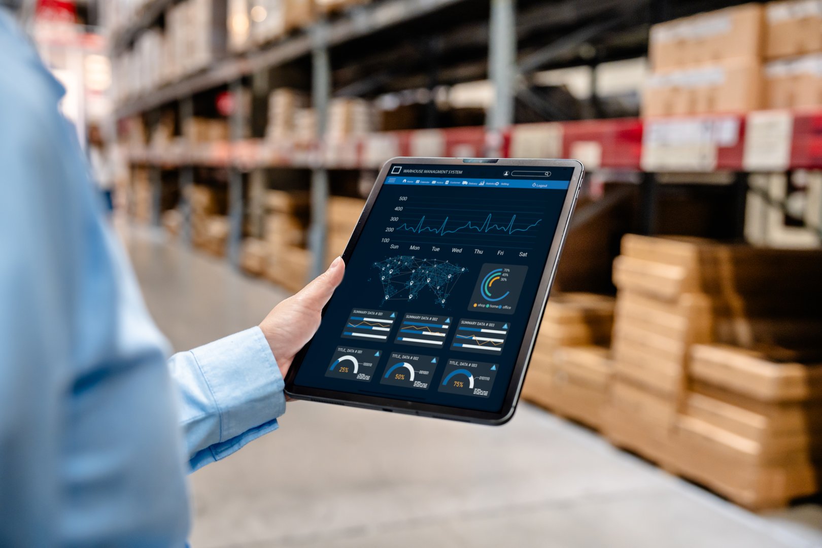 Businessman using digital tablet with warehouse management system dashboard on screen, monitoring inventory, delivery, and supply chain analytics in smart logistics distribution center